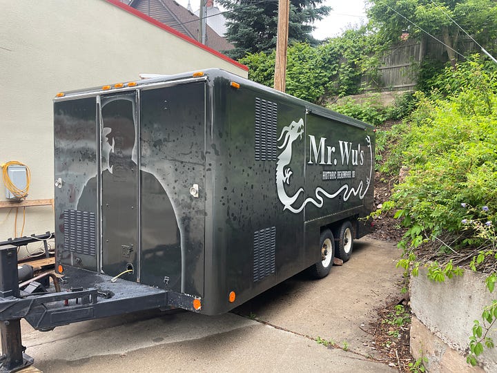 A building, a sculptor, a reactor, and food truck.