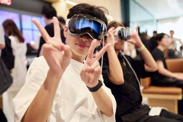 Customers demo Apple Vision Pro inside the store.