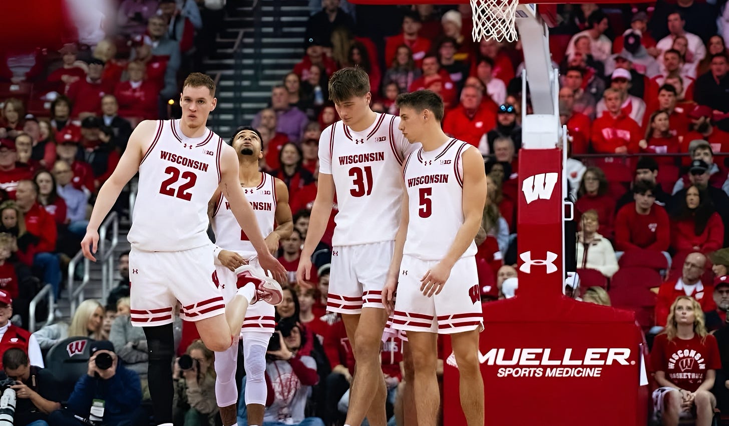 Wisconsin Badgers forwards Austin Rapp and Nolan Winter on the floor with guard Jack Janicki.