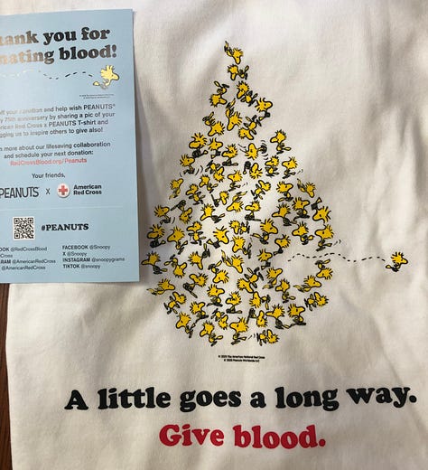 Three photos: A nametag with Victoria”; an image from teh front of a t-shirt that looks like a droplet and contains many images of teh characters Woodstock from the Peanuts cartoon; an image of Snoopy and Woodstock with the words, “A litt;e goes a long way. Thank you for giving blood.”