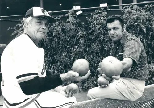Earl Weaver and Pat Santarone show off some of the groundskeepers tomatoes.