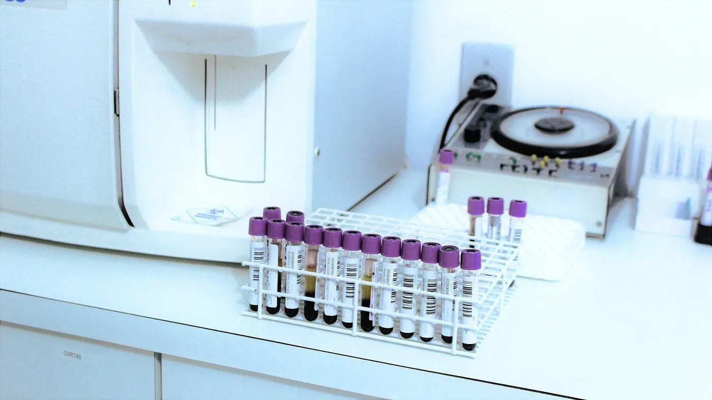 A lab counter with vials and testing machinery. A lab counter with vials and testing machinery.