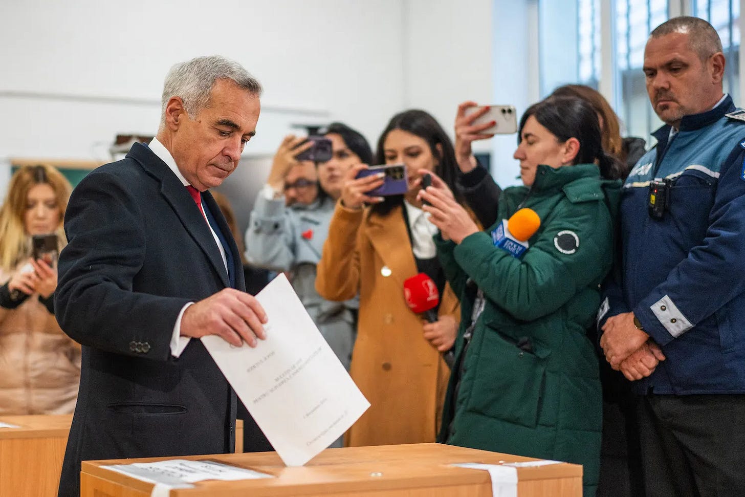 Romanian presidential candidate Calin Georgescu votes during parliamentary elections.