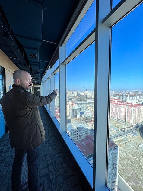 Adnan and I at the high-rise café, plus my confirmation of my flight change.