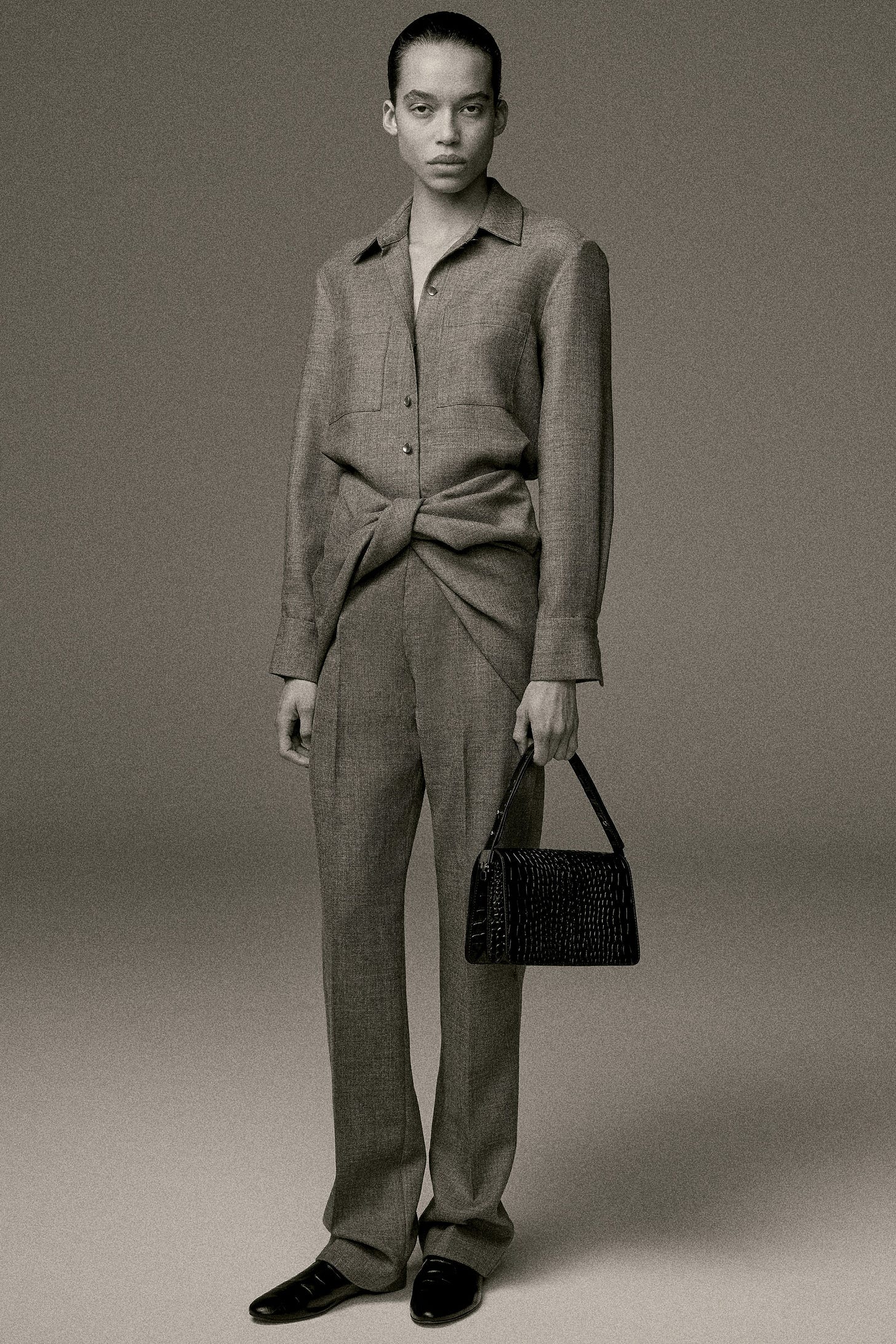 Image may contain Hannah Ferguson Clothing Formal Wear Suit Accessories Bag Handbag Coat Adult Person and Purse