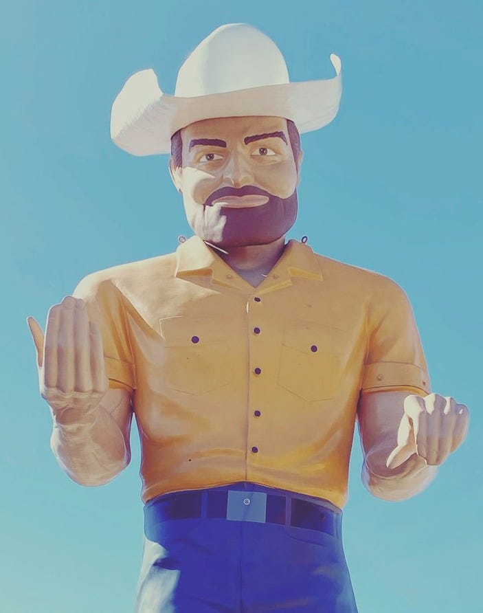man in yellow dress shirt wearing white cowboy hat