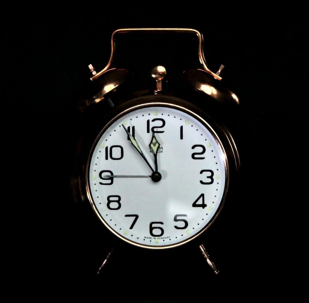 black and white analog alarm clock