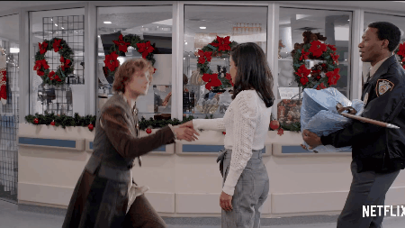 Sir Cole in The Knight Before Christmas kneeling while holding onto Vanessa Hudgens' hand