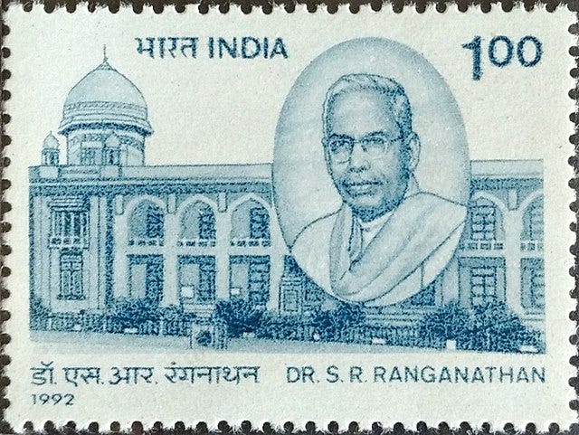 A 1992 Indian postage stamp value of Rs. 100 featuring a profile portrait of Dr. S. R. Ranganathan in Hindi and English alongside a grand building.
