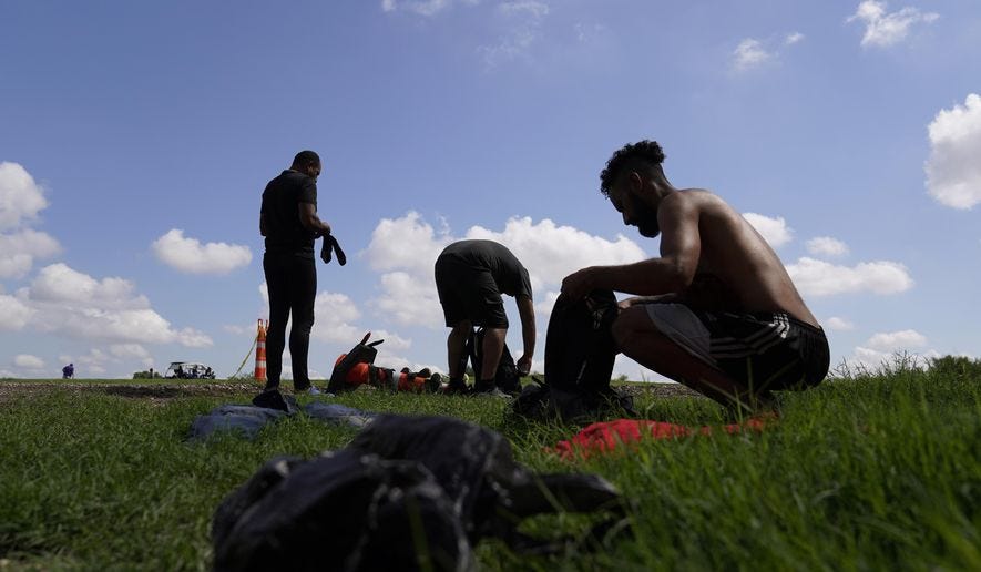 Migrants gather their personal items as they wait to be processed by the Border Patrol after illegally crossing the Rio Grande River from Mexico into the United States at Eagle Pass, Texas, Friday, Aug. 26, 2022. Venezuelans have surpassed Guatemalans and Hondurans to become the second-largest nationality stopped at the U.S. border in August 2022 after Mexicans. (AP Photo/Eric Gay, File) Migrants gather their personal items as they wait to be processed by the Border Patrol after illegally crossing the Rio Grande River from Mexico into the United States at Eagle Pass, Texas, Friday, Aug. 26, 2022. Venezuelans have surpassed Guatemalans and Hondurans to become the second-largest nationality stopped at the U.S. border in August 2022 after Mexicans. (AP Photo/Eric Gay, File)