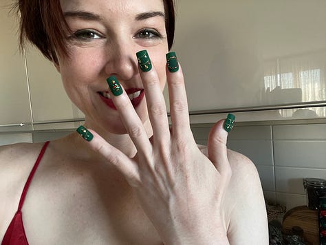 Stoya in soft green shirt and shorts in front of Pachira tree surrounded by grey Christmas creatures, Stoya in red and white Santa inspired lingerie in three sided mirror, Stoya with forest green rhinestoned Christmas nails.
