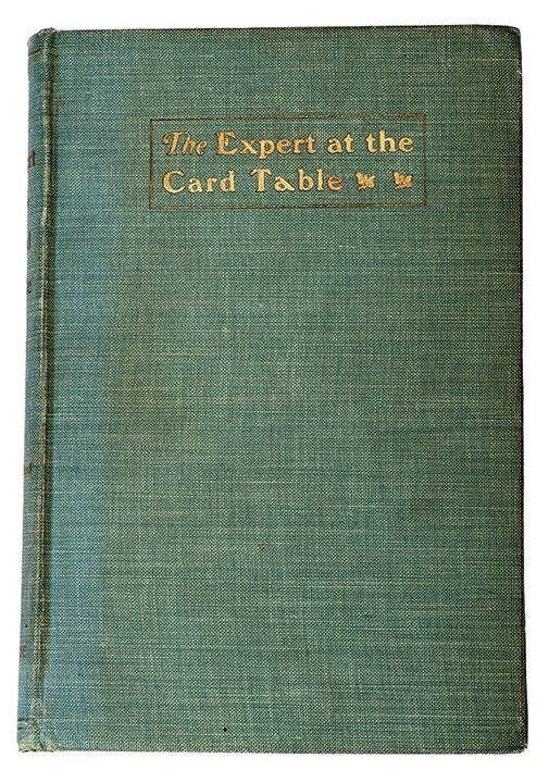 A green, cloth-covered book with the words The Expert at the Card Table embossed on it A green, cloth-covered book with the words The Expert at the Card Table embossed on it