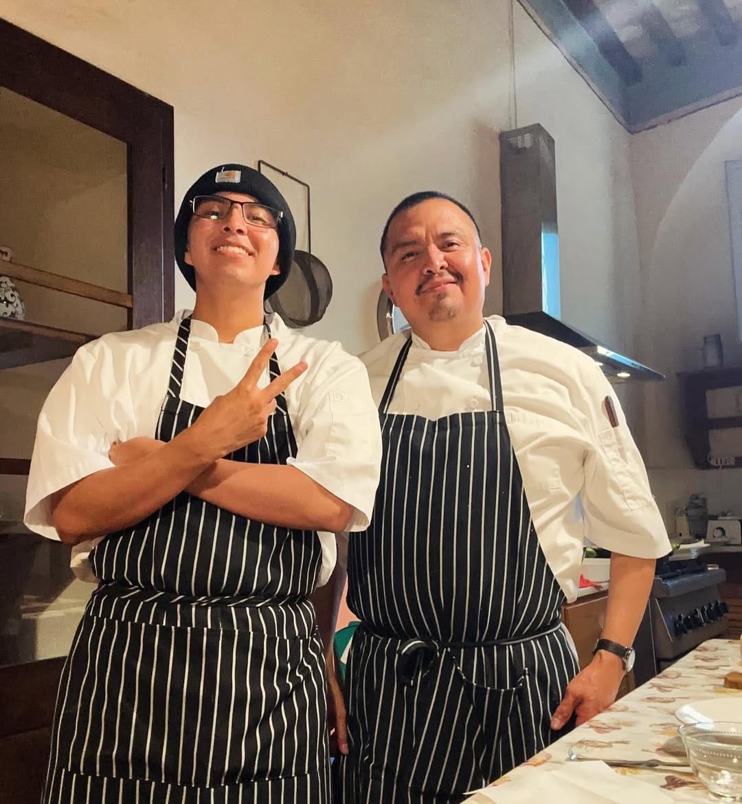Nephi and his eldest son wearing matching striped aprons