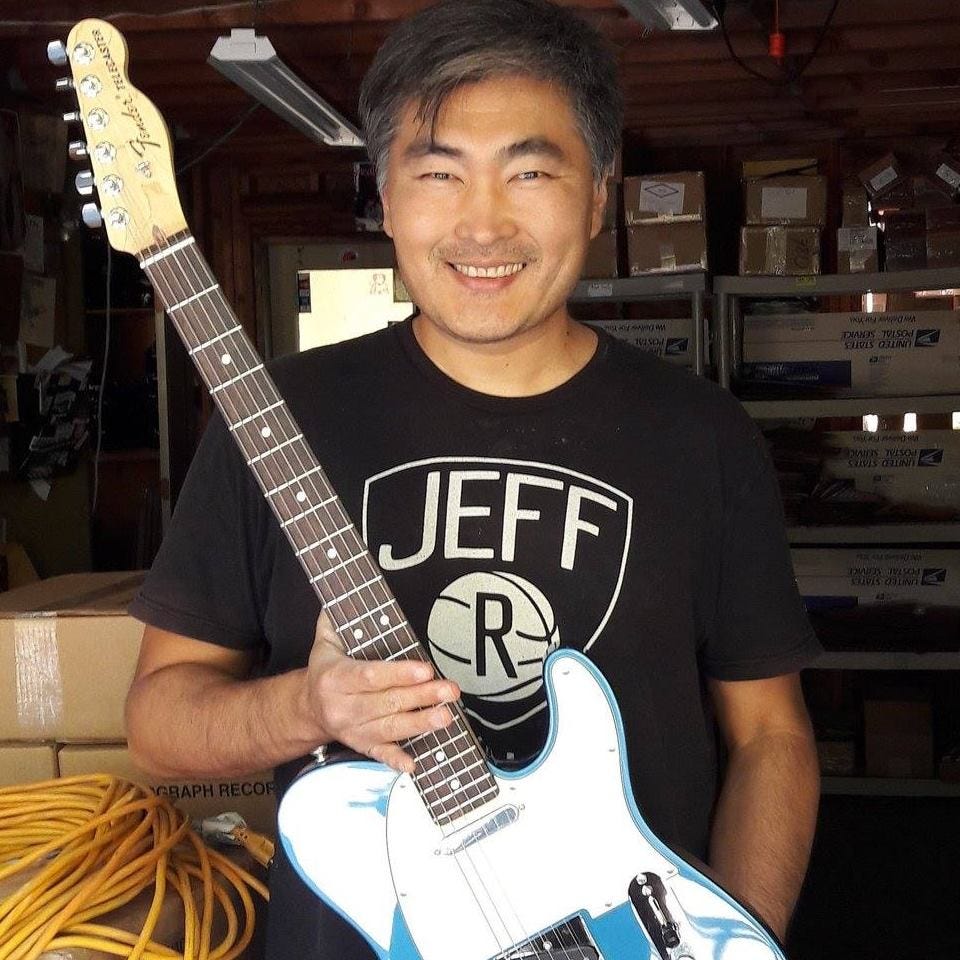 Image may contain: 1 person, smiling, guitar and indoor Image may contain: 1 person, smiling, guitar and indoor