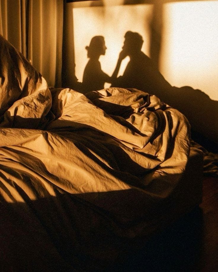 This may contain: the shadow of two people standing next to each other on a bed