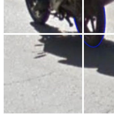 A blown up image of the square in question, revealing a tiny sliver of tire in one corner, as described.