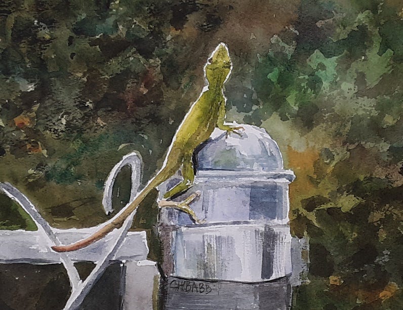 little lizard perched on the pole of a metal fence gate