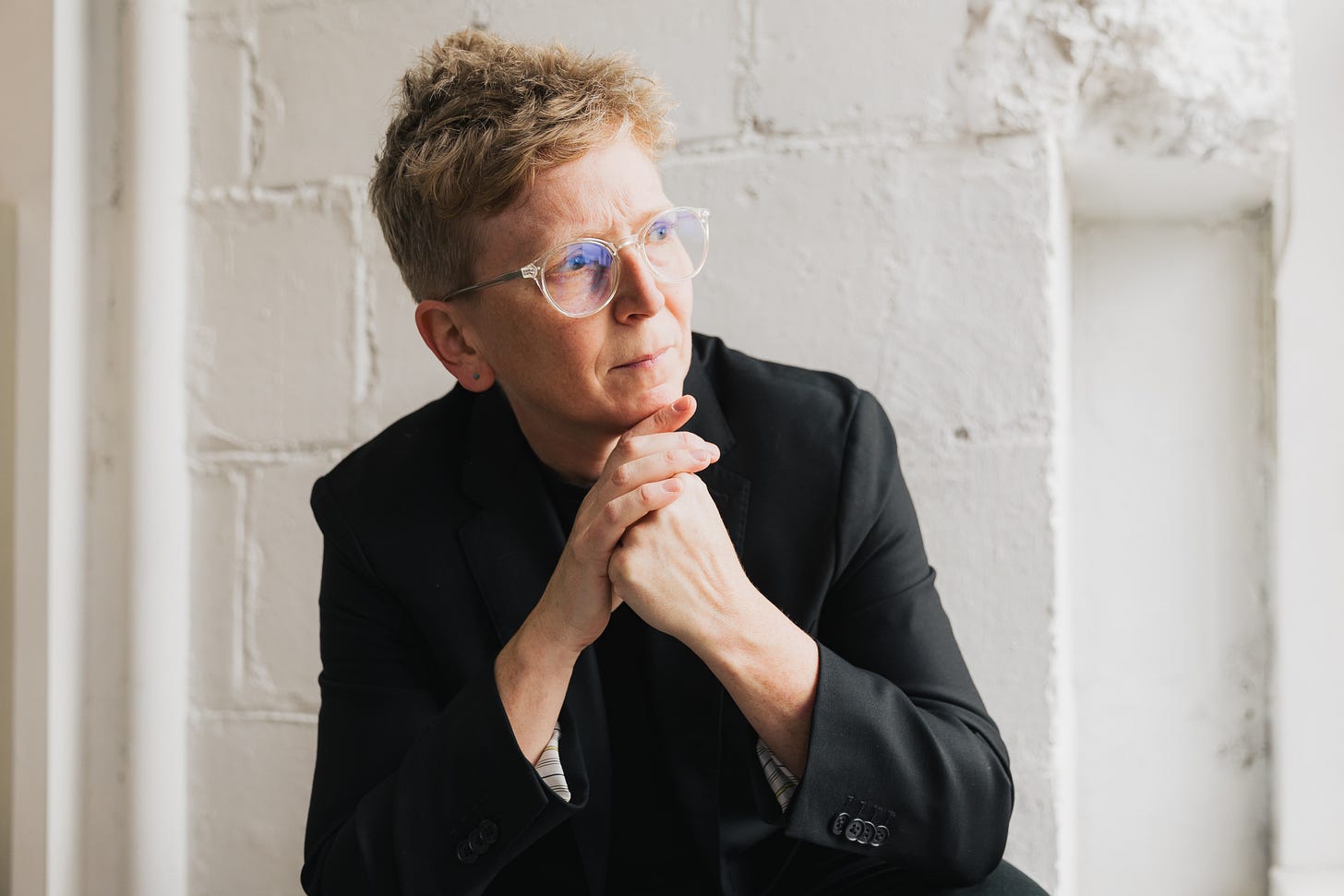 Laurie McGinley wearing a black jacket, crouched low and looking to her left with a furrowed brow. Laurie McGinley wearing a black jacket, crouched low and looking to her left with a furrowed brow.