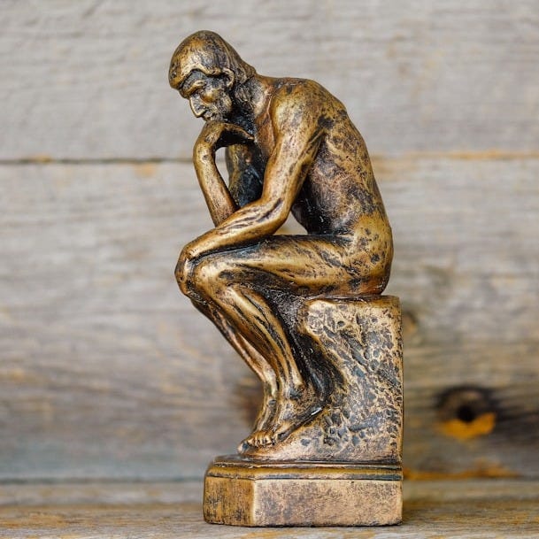 green ceramic statue of a man green ceramic statue of a man