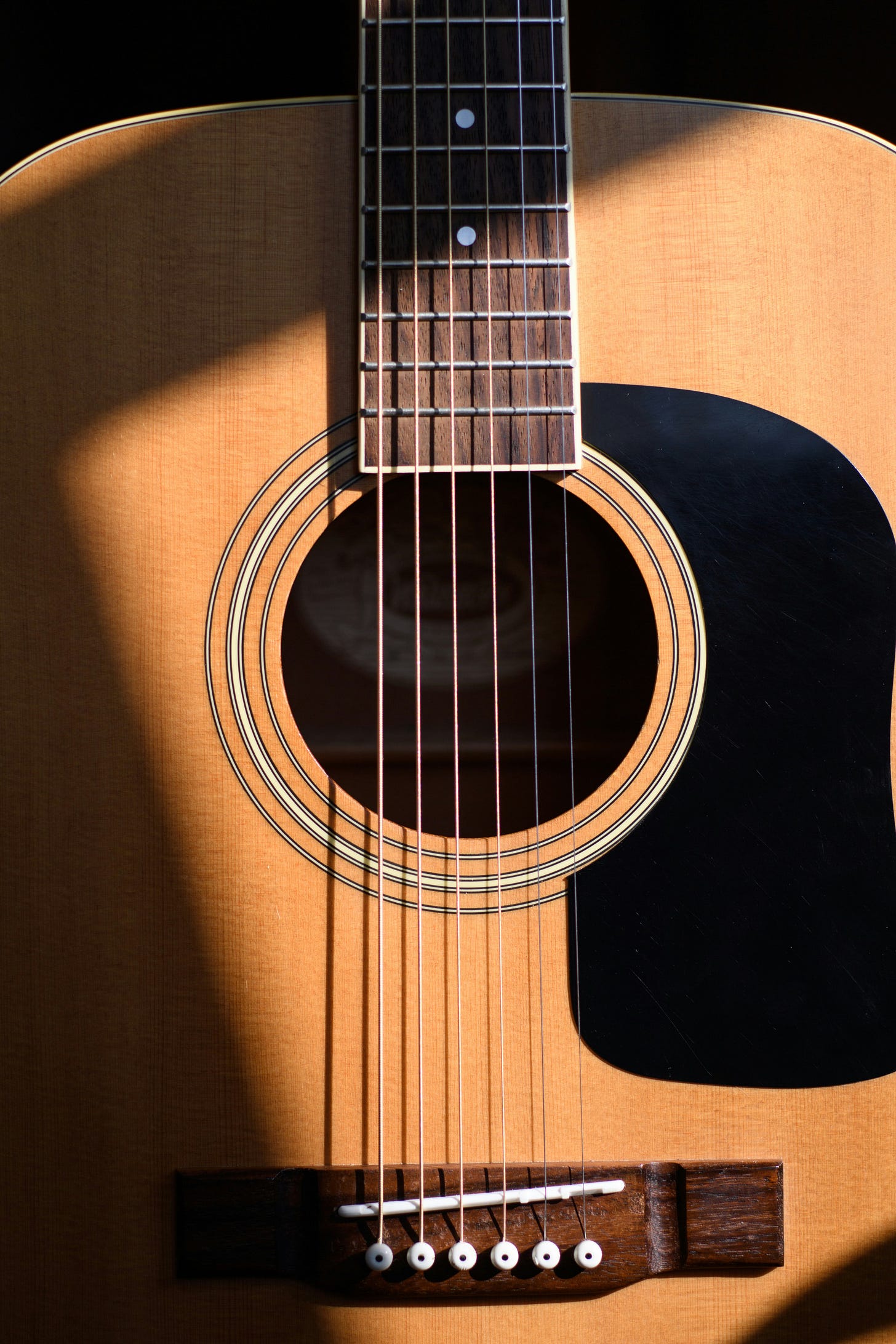 A young beginner practicing with a classical acoustic guitar A young beginner practicing with a classical acoustic guitar