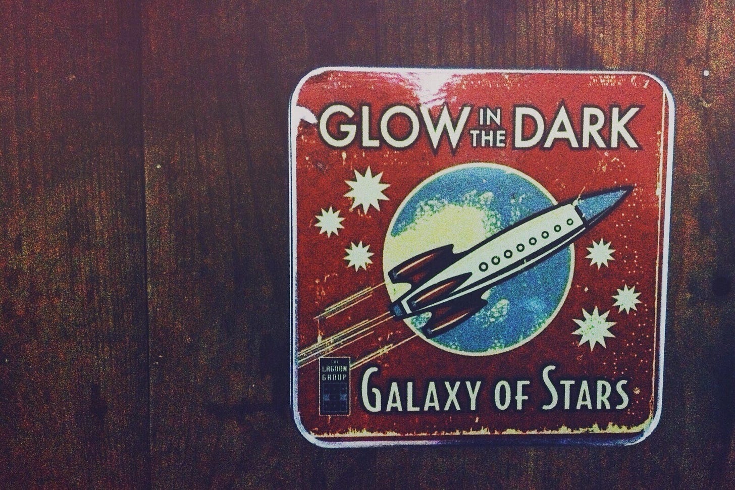 Glow in the Dark “Galaxy of Stars” tin box with a rocket flying across the moon. Photo Credit: Nancy Forde Glow in the Dark “Galaxy of Stars” tin box with a rocket flying across the moon. Photo Credit: Nancy Forde