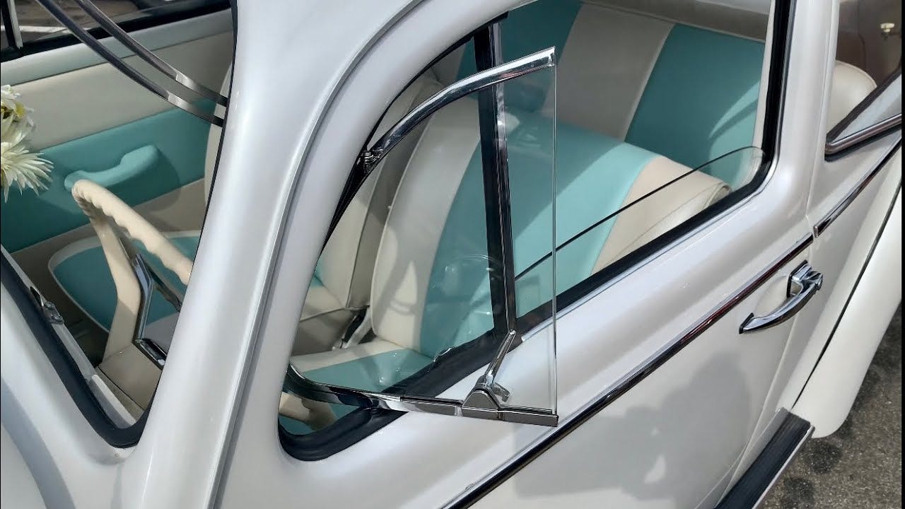 A Volkswagen Beetle wing window. A Volkswagen Beetle wing window.