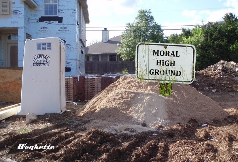 photo of a home construction site with a partly-built 2-story house background left. In the foreground are a porta-potty, piles of bricks, and a large pile of fill dirt.  A sign reading 'moral high ground' has been digitally added atop the pile of dirt. 