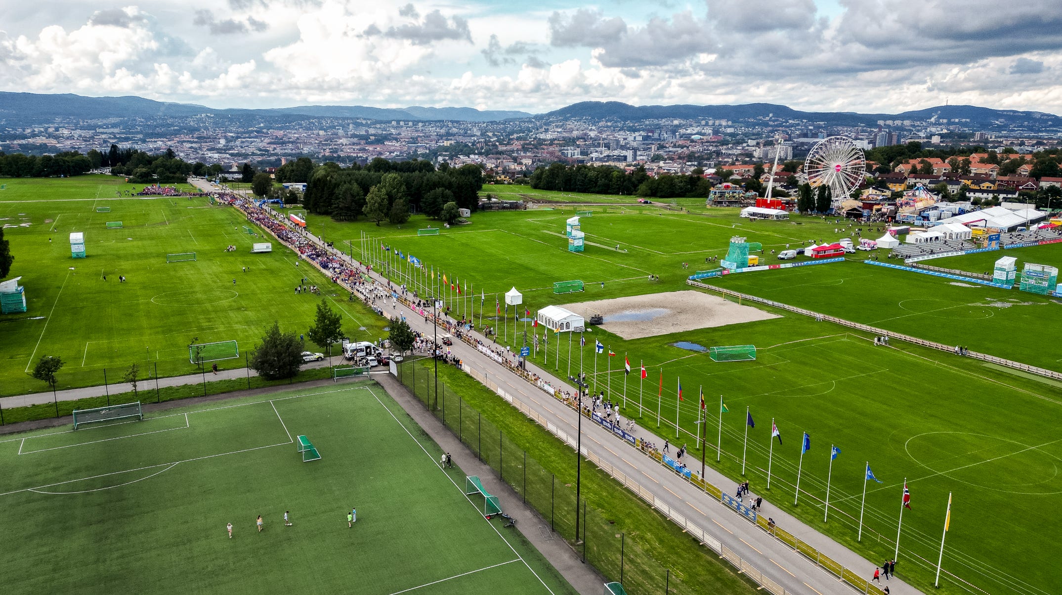 Aerial view of Norway Cup at Ekebergsletta in Oslo with football fields, crowds, flags and tournament facilities. Aerial view of Norway Cup at Ekebergsletta in Oslo with football fields, crowds, flags and tournament facilities.