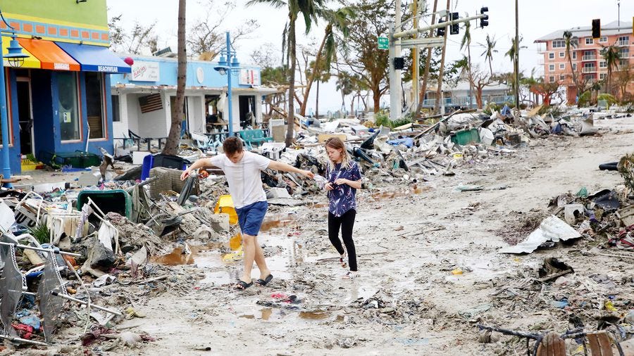 Jake Moses, 19, left, and Heather Jones, 18, of Fort Myers, explore a section of destroyed businesses at Fort Myers Beach on Thursday, Sep 29, 2022. The community was mostly destroyed after Hurricane Ian made landfall on Wednesday. Jake Moses, 19, left, and Heather Jones, 18, of Fort Myers, explore a section of destroyed businesses at Fort Myers Beach on Thursday, Sep 29, 2022. The community was mostly destroyed after Hurricane Ian made landfall on Wednesday.