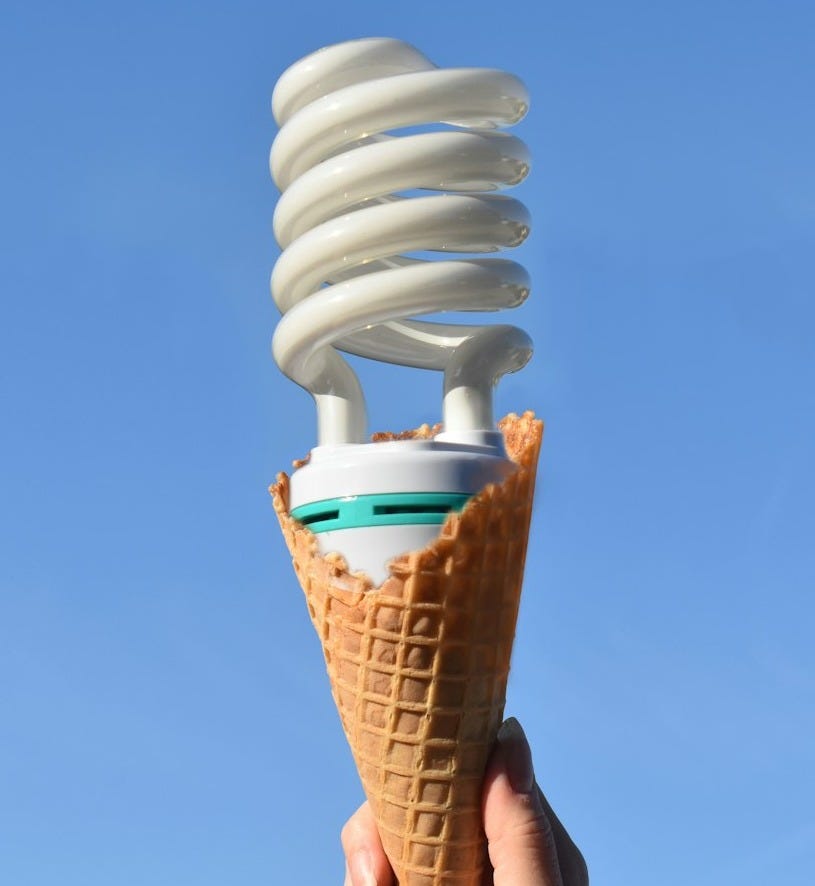 person holding white ice cream cone