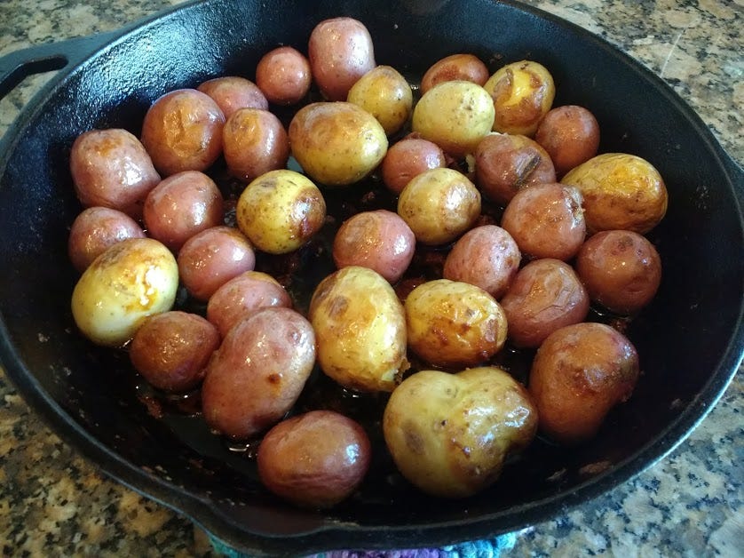  After bubbling and browning in the chicken drippings, these babies cooked up with a nice crisp skin that exploded into creamy deliciousness when broken into with a fork. 