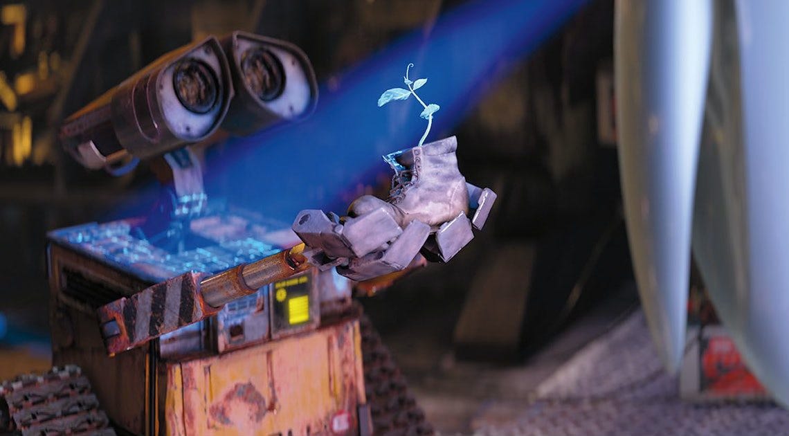 wall-e porte une plante dans une botte