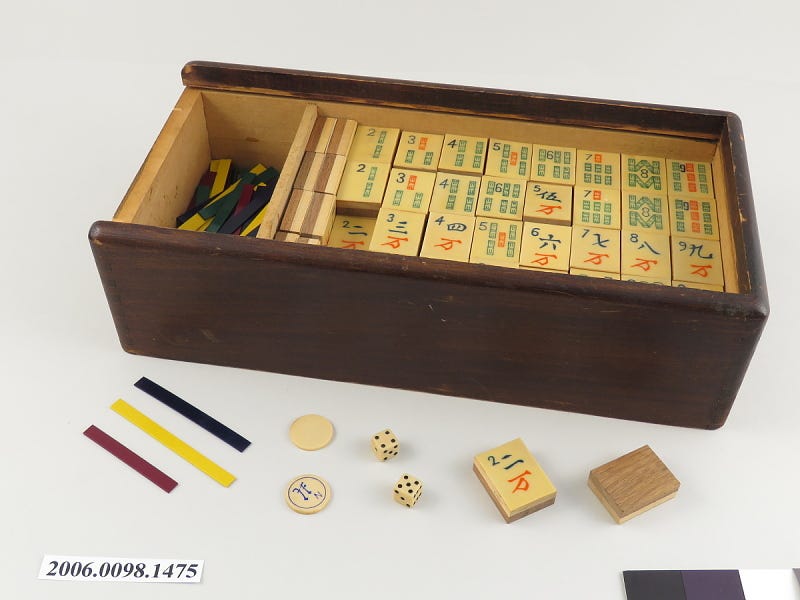 a photo of a mah jong set in a wooden box a photo of a mah jong set in a wooden box