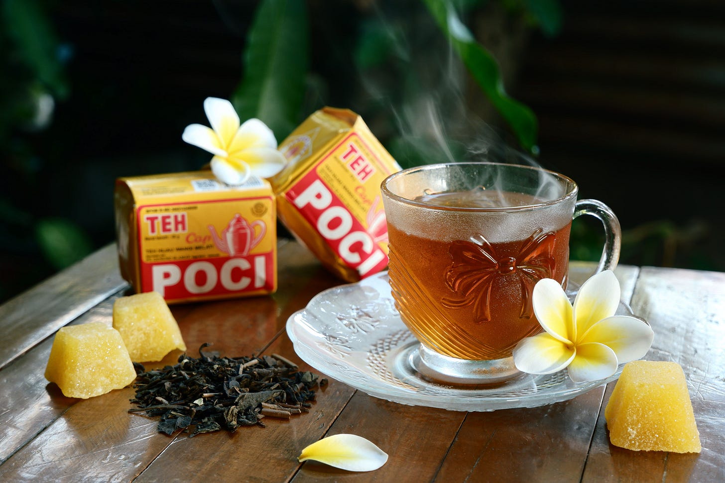 A cup of rich black tea featuring cocoa notes, loose leaves, and mixed herbs on a rustic surface. A cup of rich black tea featuring cocoa notes, loose leaves, and mixed herbs on a rustic surface.