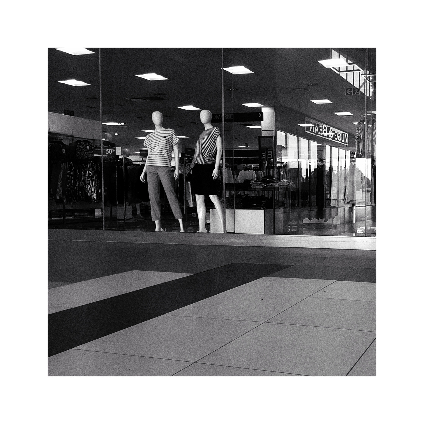 Two mannequins looking at the camera.