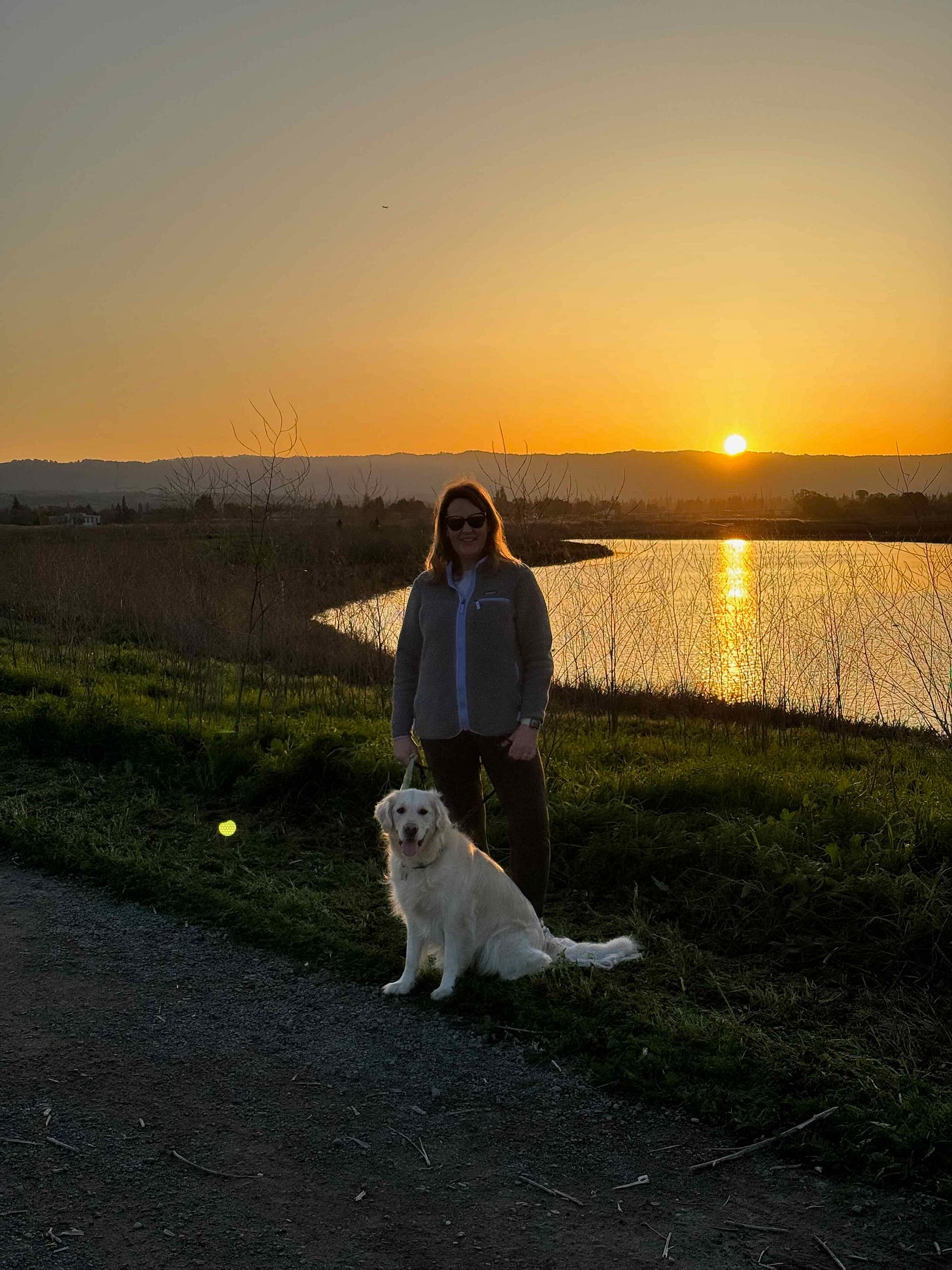 Tracy walking her dog at sunset - a quiet moment of joy and presence.