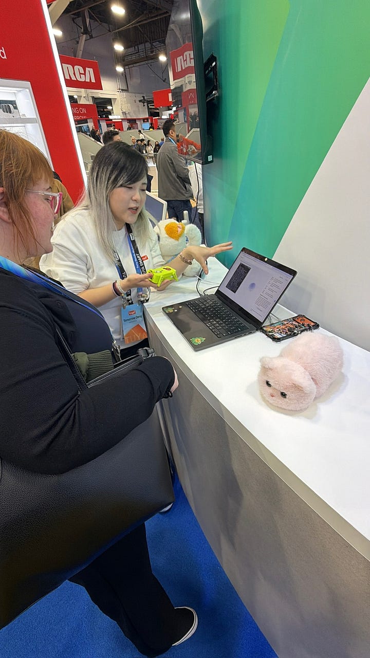 A five-image gallery from Tuya’s CES demo showing attendees interacting with Tuya’s smart-home platform: booth displays outlining how conversational prompts configure devices, close-up shots of the interface on a laptop, and Tuya staff demonstrating how natural-language commands generate on-device automations.
