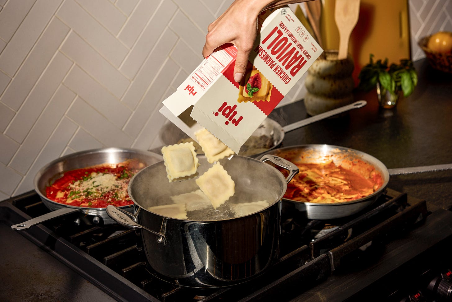 Ripi ravioli being poured into a pot on the stovetop 
