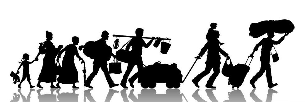 Silhouette of migrants carrying their belongings as the travel on foot.