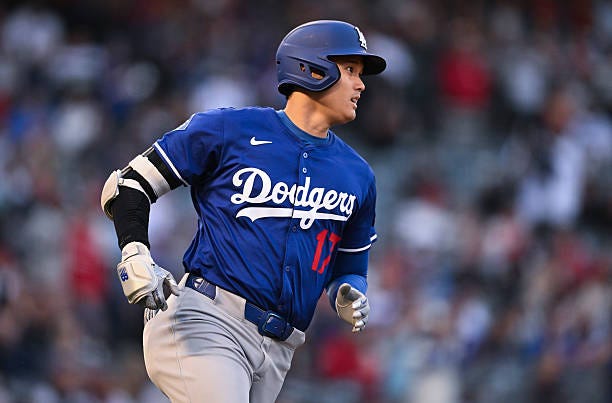 Shohei Ohtani of the Los Angeles Dodgers runs to first base the Los Angeles Angels at Angel Stadium of Anaheim during a spring training game on March...