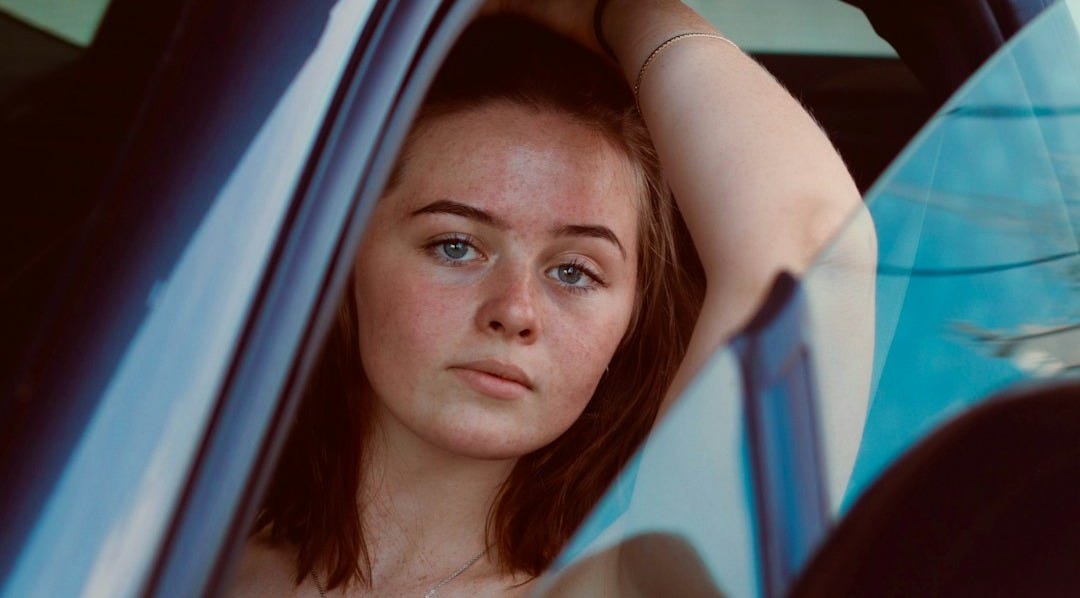 a woman sitting in a car