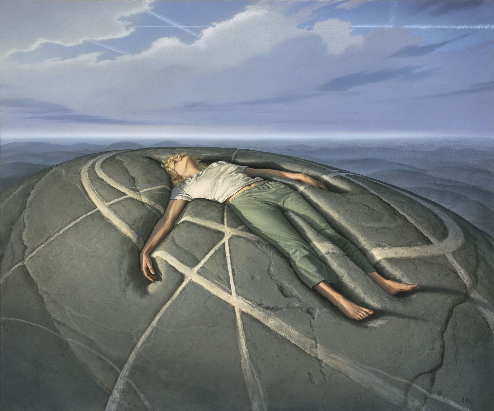 With head laid back and arms spread, a woman with golden blonde hair sinks back into a mound of solid gray rock. Her eyes are closed even as her face is turned up to the sky. She wears a white t-shirt and drab green sweatpants, but her feet are bare. Hazy hills roll in the distance beyond. Low-lying clouds mostly obscure the sky, but a pattern of crisscrossing contrails can be seen higher up echoing the pattern of curves and intersecting lines drawn in the round of the stone where the woman rests. The pattern is painted on the rock in strokes of varying weight and in the immediate foreground those lines seem slightly recessed. With head laid back and arms spread, a woman with golden blonde hair sinks back into a mound of solid gray rock. Her eyes are closed even as her face is turned up to the sky. She wears a white t-shirt and drab green sweatpants, but her feet are bare. Hazy hills roll in the distance beyond. Low-lying clouds mostly obscure the sky, but a pattern of crisscrossing contrails can be seen higher up echoing the pattern of curves and intersecting lines drawn in the round of the stone where the woman rests. The pattern is painted on the rock in strokes of varying weight and in the immediate foreground those lines seem slightly recessed.
