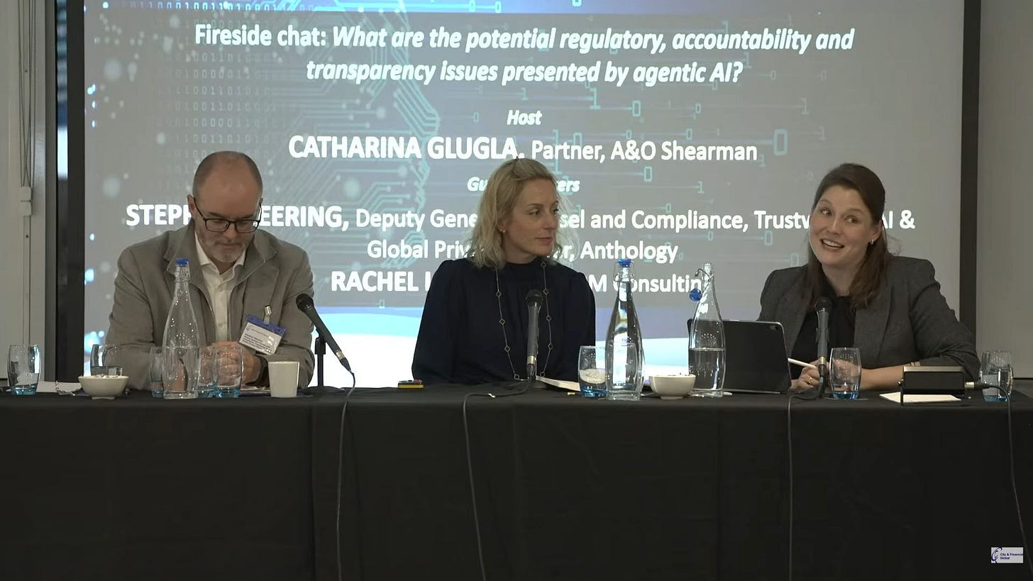 Photo of panel - At the 3rd Annual AI Regulation Summit with fabulous co-panelists Rachel Lum and Catharina Glugla. Me looking down at table, hands folded.