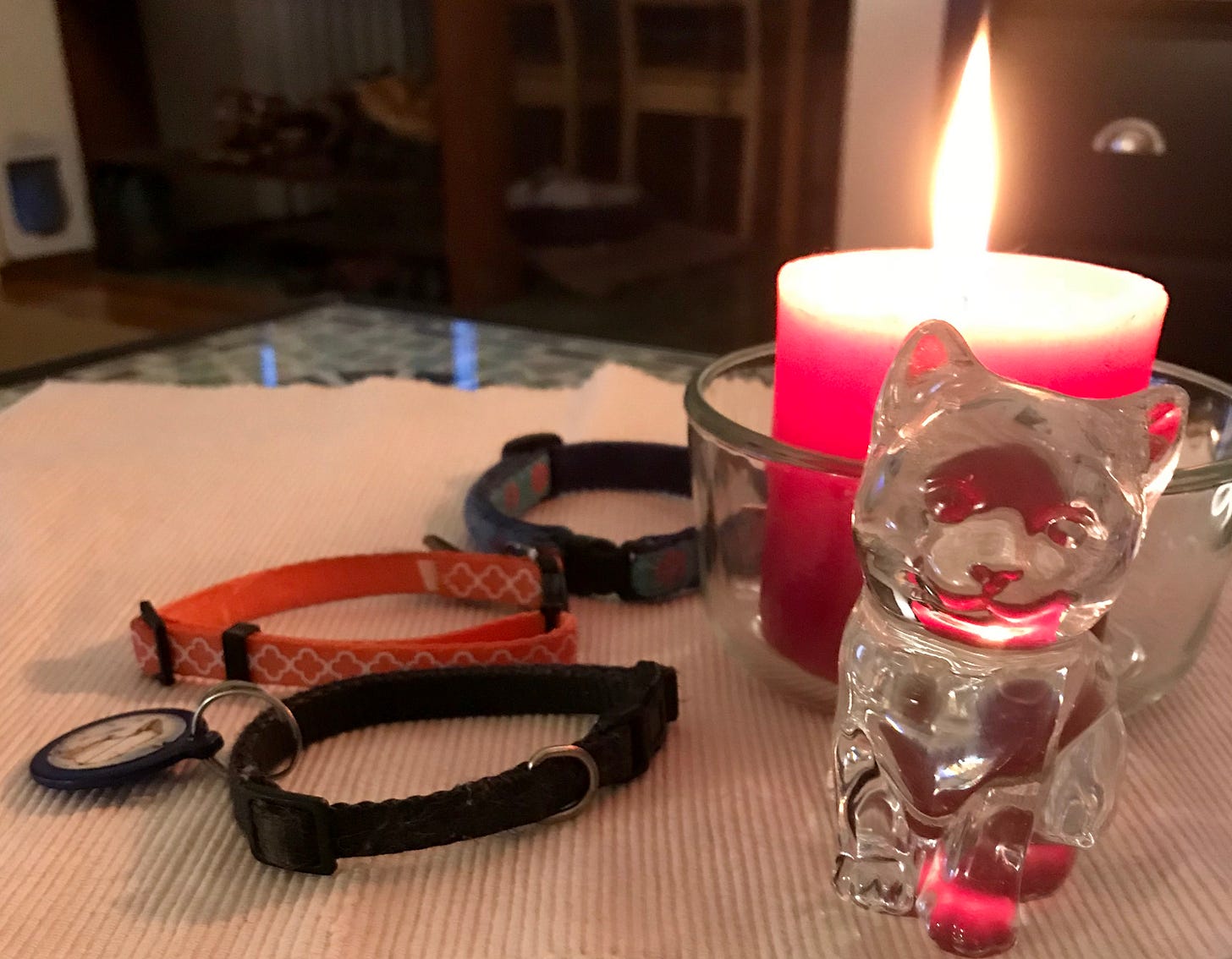 three cat collars and a candle