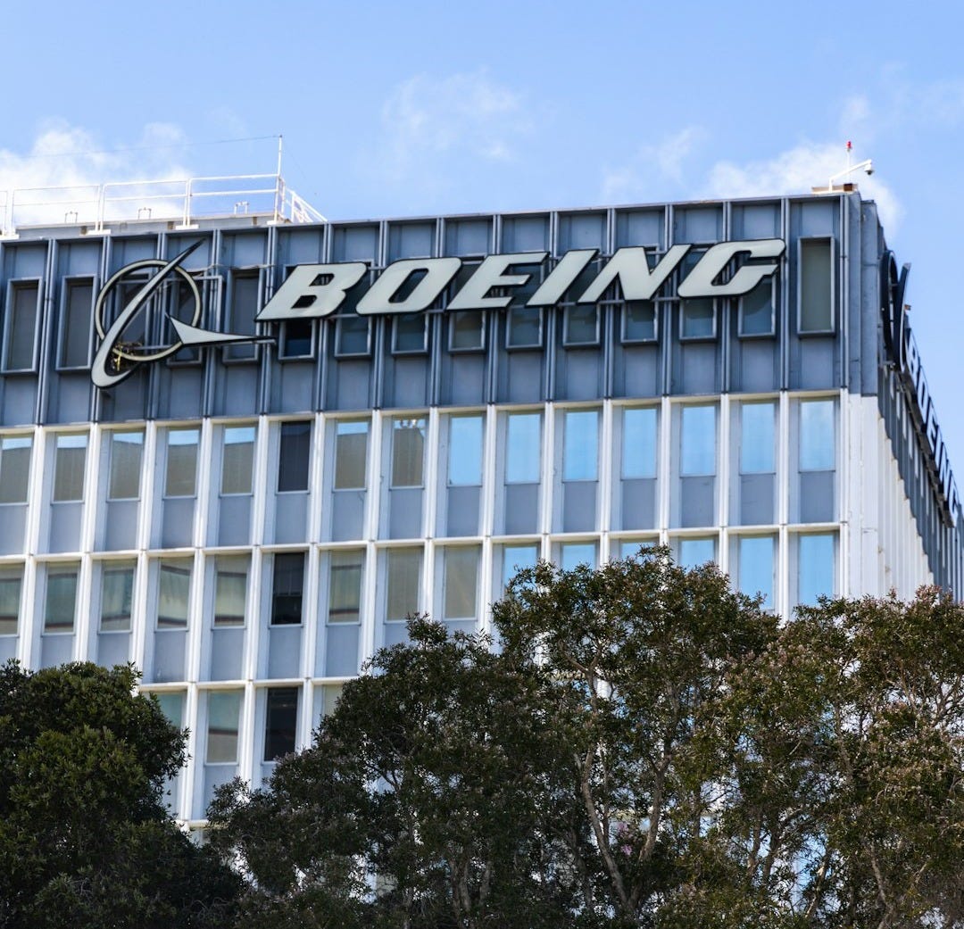 a tall building with a sign on top of it a tall building with a sign on top of it