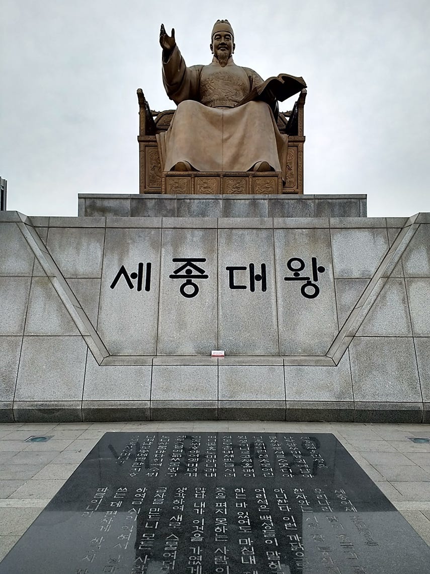 A statue of a person sitting on a chair

AI-generated content may be incorrect.