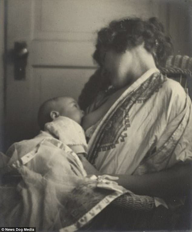 This may contain: an old photo of a woman holding a baby