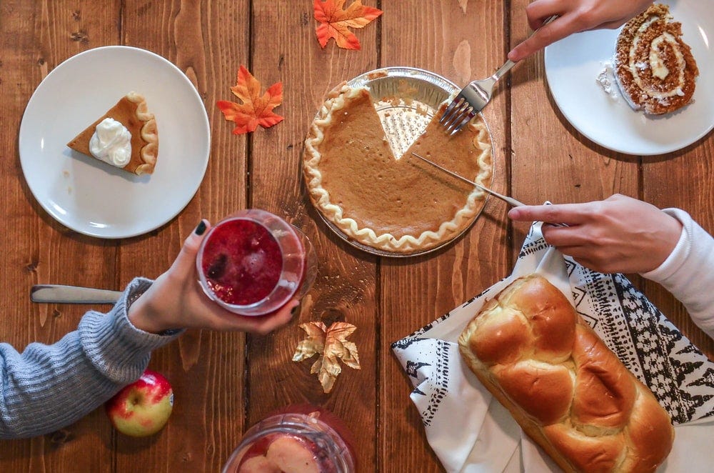 person slicing pie beside bread person slicing pie beside bread