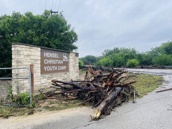 Uprooted tree limbs are piled by the main entrance to Hensel Christian Youth Camp in Marble Falls, Texas. Uprooted tree limbs are piled by the main entrance to Hensel Christian Youth Camp in Marble Falls, Texas.