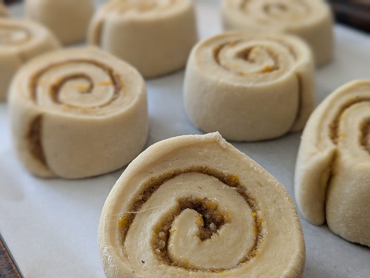 Neatly slicing rolls with dental floss, ready to rise on baking sheet